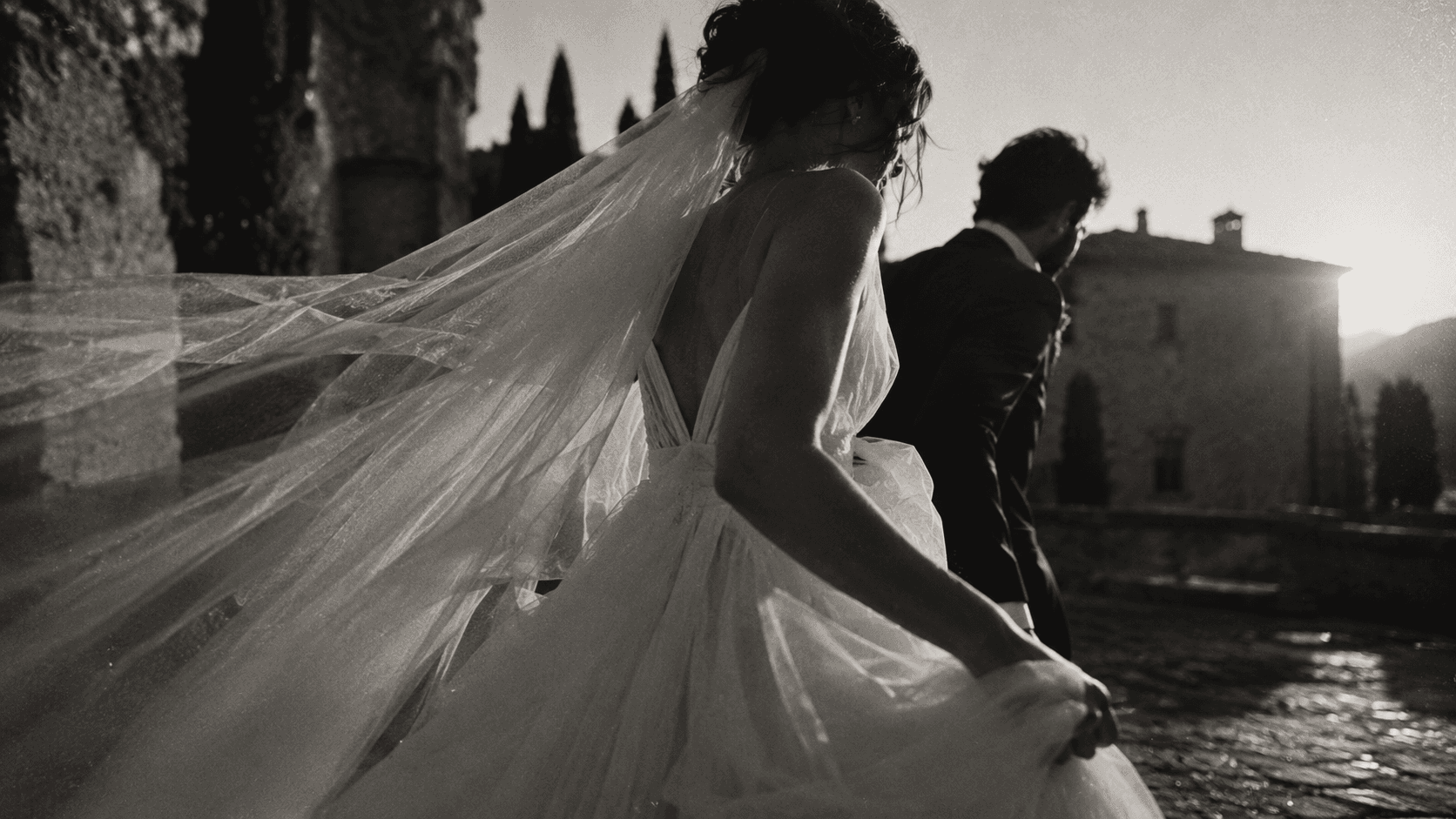 A newly married couple walking through light and movement